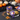 Halloween ghost cupcake jar with purple frosting and a Spooky Night lid, styled on a black table with jack o lantern pumpkins, cobwebs and candy corn