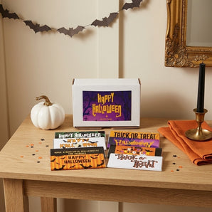 Halloween personalized chocolate bars gift box with eight printed bar wrappers fanned out on an entry table