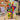 Halloween sweet candy bouquet of full size candy bars and Halloween snack bags fanned from a candy carton on a desk