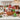 Holiday Cheer Christmas gift basket in a woven wood basket with pretzels, peppermint bark and tea on a marble kitchen island
