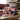 Holiday Play Ball gift in a navy Red Sox cap filled with ballpark snacks and candy on a den coffee table by the Christmas tree