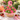 Ladybug Blossoms Cupcake Bouquet of 19 cupcakes domed in a round wicker basket, hot pink buttercream swirls and green grass cupcakes with fondant ladybugs and ladybug picks, a Sweet as a Bug topper, on a garden table with strawberries and lemonade
