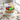 Custom Logo Cake with a colorful hand-piped buttercream logo and sprinkle sides