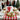 Merry Christmas round iced sugar cookies on a green plate with a HO HO HO bow gift box at a holiday cookie exchange