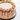 Mocha Cake top view with mocha buttercream rosettes and chocolate drip