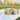 Personalized Easter Tackle Box of Candy, a clear tackle box of pastel Easter candy with a personalized name, on a picnic blanket after an egg hunt