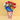 Popcorn Bucket, a red and white striped popcorn tub filled with caramel popcorn, Oreo Minis, Snack Factory Pretzel Crisps, jelly beans and a rainbow swirl lollipop on a yellow backdrop