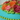 Another view of the Secret Garden Cake covered edge to edge in hand-piped multicolor buttercream roses