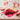 Valentine's Day Cupcake Cake, red, pink and white rosette cupcakes arranged in a heart on a pink board, on a Galentine's party dessert table with pink lemonade