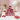 Valentine's Day Personalized Candy Pyramid, six clear cubes of red and pink candy personalized with a name, on a white bedroom vanity with pink tulips