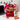 Valentine's Day Personalized Gift Tote, a red tote embroidered with a name and filled with Haribo, Popcorners, candy and a heart lollipop, on a dorm room desk