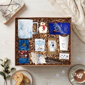 Warm Winter Wishes mug gift box with a marbled ceramic mug, hazelnut coffee, chocolates, cocoa and winter treats