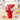 You're So Sweet Valentine's Day Bucket, a red bucket of Skittles, sweetheart cookies, jelly beans, popcorn and a heart lollipop, on a kitchen table on Valentine's morning