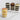 Four layered cupcake dessert jars on a marble surface