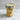Glass jar with layered cupcake dessert and wooden spoon on a marble surface