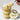 Layered cupcake dessert in a jar with a customizable floral-labeled lid on a white background