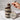 Layered cupcake dessert in a jar with a personalized lid on a marble surface