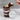 Chocolate cupcake in a jar with Easter-egg decorations on a marble surface with a Happy Easter lid design. 
