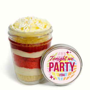 Layered cupcake dessert in a jar with a colorful 'Tonight we PARTY Lydia' lid on a white background