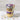 Glass jar with layered cupcake dessert mix and customizable Halloween-themed label on a white background