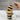 Layered cupcake dessert in a jar with a spoonful being lifted, against a marble background with customizable lid label branding.