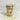 Jar of layered cupcake dessert with a decorative label lid on a marble background
