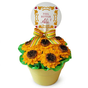Decorative cupcake with sunflower design and 'Feel Better Ali!' message on a white background