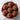 Chocolate cupcakes with red heart decorations on a marble surface