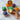 Halloween-themed cupcakes with colorful frosting and a hand holding a green cupcake.