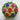 Decorative cupcakes with colorful rose designs on a marble surface