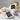 S'mores cake with a slice on a plate, surrounded by graham crackers and marshmallows.