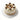 Decorative cake with white frosting, chocolate balls, and coconut flakes on a white stand.