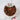 Chocolate wreath cake with 'Deck the Halls' sign on a marble background