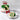 Christmas-themed cake with a slice on a plate, decorated with green and red icing, on a marble surface.