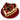 Heart-shaped cake with white frosting, red strawberries, and chocolate pieces on a red plate.